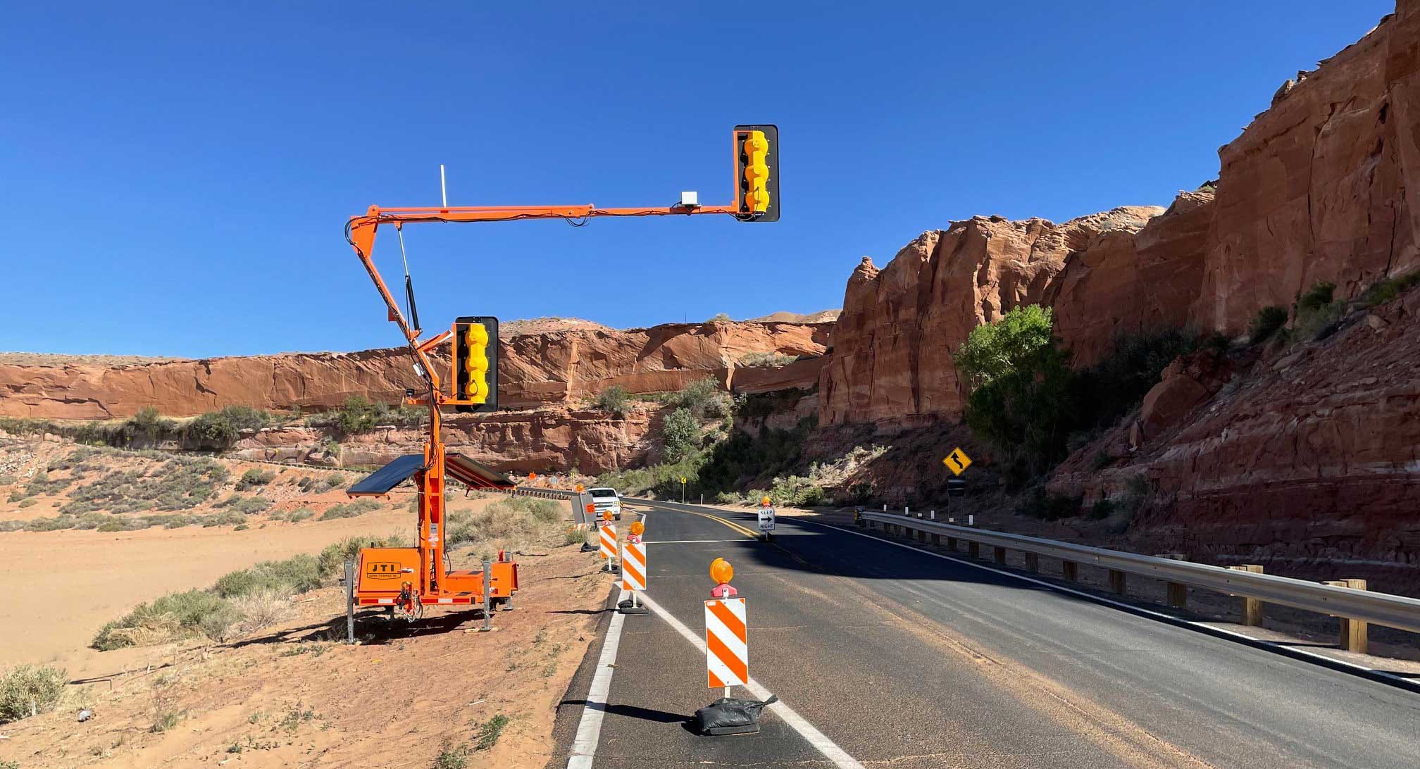 Portable Traffic Signal in Work Zone Pilot car operations work zone with portable traffic signal on a two-lane road