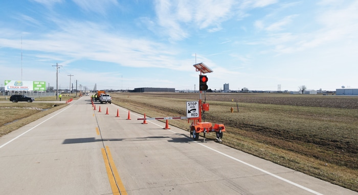 Automated flagger vs human flagger, device at the end of a cone taper with the crew working inside the closure